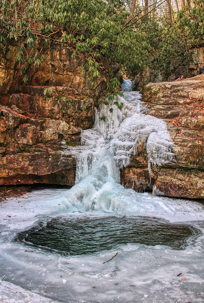 The main waterfall at Blue Hole Falls in the Stoney Creek area of Carter County, Tennessee, is at around a 2,240-foot elevation. Seven consecutive days of temperature well below freezing led to the surface freezing of the falls and much of its pool.