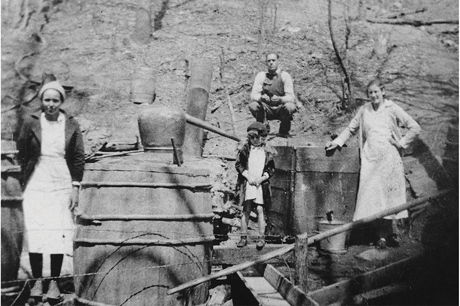 Joel Quinn and his family pose at their mountain still near Endicott, Franklin County, circa 1930.