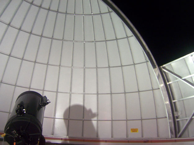 The Primland Resort observatory telescope casts a shadow against the inside of the dome.