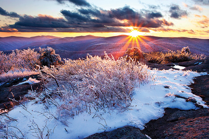 The last light of sunset illuminates a sparkling layer of rime ice on Spy Rock near Montebello on Virginia’s Appalachian Trail.