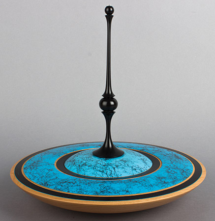 Lidded vessel with blue gesso and black spider paint.