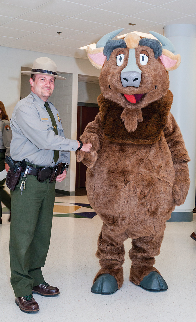 Schaberl plays Buddy the Bison with Chief Ranger Brian Sikes. Courtesy of Jim Schaberl