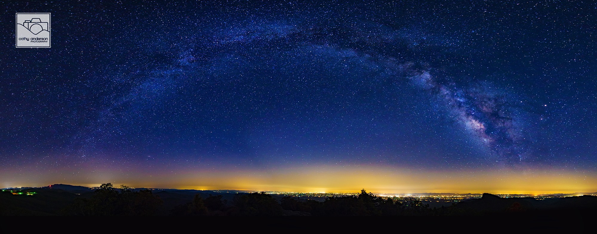 Look Up - FEEL FREE TO SHARE!

During the late winter and early spring months, the Milky Way rises low in the sky in the early morning hours. Later in the year, it rises higher and higher throughout the summer months until it is almost directly above our heads. Creating a Milky Way panorama is virtually impossible in the summer months, making this time of year the perfect period of time to create an image like this. To give this image scale (taken from the Hawksbill summit), the peak of Table Rock sits just below the Galactic Core on the right side of the image and the lights of Morganton stretch out below the entire expanse of the Milky Way arch.

Connect with me!
Website: www.cathyandersonphotography.com
Facebook: www.facebook.com/CathyAndersonPhoto
Instagram: http://instagram.com/cathyandersonphoto
Twitter: http://twitter.com/cathyanderson27 (@cathyanderson27)
Flickr: https://www.flickr.com/p…/125802685@N03/(cathyandersonphoto)
500px: http://500px.com/CathyAnderson
Google+: https://plus.google.com/+CathyAndersonPhotography
YouTube: https://www.youtube.com/CathyAndersonPhotography
