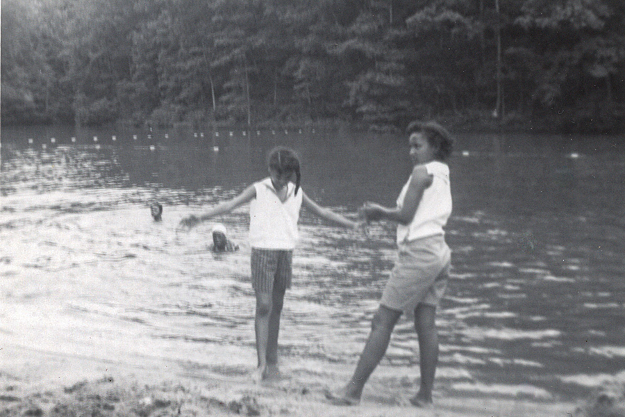 Ettrula Clark Moore and her friend Anelia Anderson Adkins wade in the water of Green Pastures Lake.