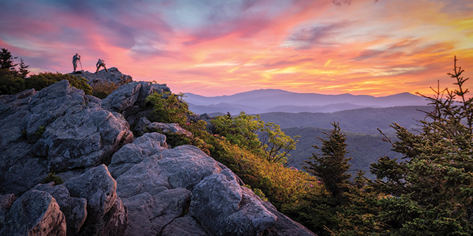 Location is Grandfather Mountain in Linville, North Carolina, two miles south of the Blue Ridge Parkway at MP 305. From the photographer: “This image was taken in early June at the top of Grandfather Mountain during a photography conference.  Two other excited photographers were also capturing the sunset."