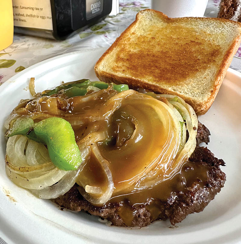 Hamburger steaks are topped with a flavorful brown gravy glaze.