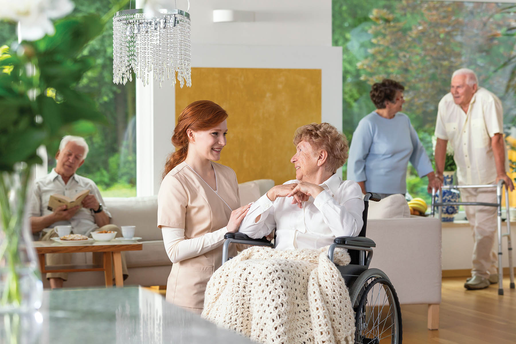 Seniors in a luxury living room of a private retirement home.
