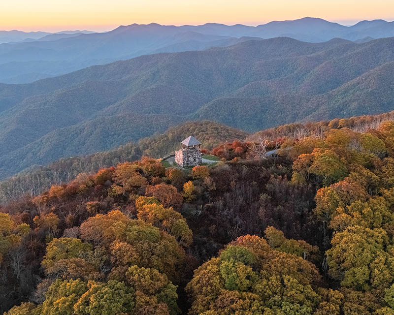 Wayah Bald in North Carolina’s Nantahala National Forest. From the photographer: “I always feel so lucky to catch a glowing sunset high up in the mountains, and standing at the tower in peak autumnal colors can’t be beat.” Photo by Trevor Bamford