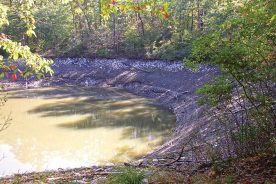 West Virginia’s Trout Pond, in Hardy County, was full in 2003 when the shot below was taken. Leakage out of what was until recently a blocked limestone sinkhole has reduced the pond to its current level, as seen above.
