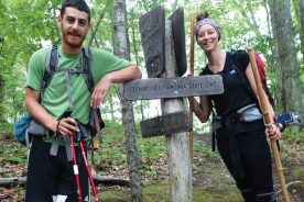 Noah Naseri and Kayla Carter pause at the Virginia/Tennessee line during their Appalachian Trail hike.