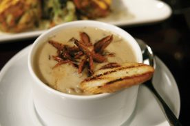 The Roux version of mushroom bisque is garnished with grilled baguettes and splashes of sherry.