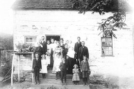 A group of unidentified Zittles clusters around the family home in this undated photo.