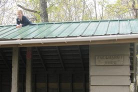 Tyler climbs Fullhardt Knob Shelter roof after climbing Fullhardt Knob