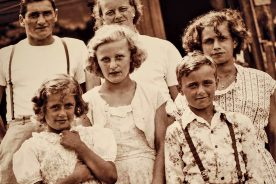 A happy 8-year-old Eula Mae standing in front of her father, Woodrow, in this Golding family photo taken in 1952.