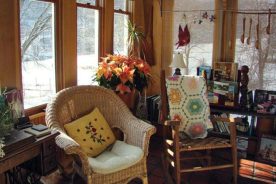 A cozy interior is complemented by stunning views of the forest and fields of wildflowers surrounding Snug Hollow Farm.