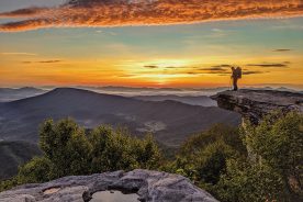 Virginia’s McAfee Knob, on the Appalachian Trail near Roanoke, offers 270-degree views including the Peaks of Otter (twin peaks on horizon to the right of the hiker).