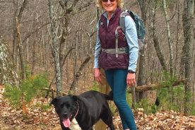 Hiking companions Gail Rheinheimer and Cookie pause on the trail.