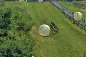 zorbing in pigeon forge
Climb inside a giant inflatable globe that’s tucked inside a larger ball and roll down a hillside. It’s called Zorb and it’s one of the newest adventure sports out of New Zealand. Pigeon Forge, Tenn., boasts the first Zorb site in North America.
There are some choices here – you can be strapped in a safety harness inside a dry ball known as a Zorbit or you can spin and slosh your way down the mountainside in a Zydro ball that’s partially filled with water. Strapped participants careen down the slope solo while the water balls can carry up to three people at a time. If you stand at the top of the run and lose your nerve, they’ll give you a refund. The daredevils who do accept the challenge can relive the experience on video. A camera is tucked inside the ball to record all the fun.
The Pigeon Forge site offers a straight track and a more challenging zigzag course. The Zorbit travels only the straight path. Check it out at zorb.com.
~Marla Hardee Milling