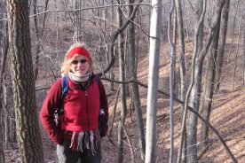 Gail in front of what looks like a classic Appalachian mountain sinkhole along the Chestnut Ridge Loop Trail.