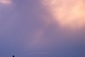 Lingering twilight slowly overtakes a porch “setter” at a rustic cabin northeast of the Smokies.