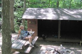 Gail, comfortable on the picnic table at tucked-away Boblett's Gap Shelter.
