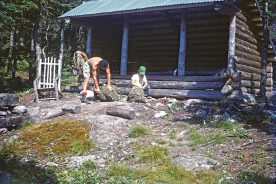 The Appalachian Trail shelter in this 1955 photo is strongly suggestive of old ways remaining alive today; the chair and the packs not so much. Kurt Rheinheimer (green hat), here with his late father, also seems to have changed a bit over those years.