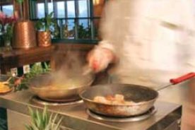 The staff at Asheville, N.C.’s Grove Park Inn Resort & Spa create such regionally inspired dishes as shrimp and grits with ham gravy.