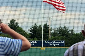 Saluting the flag prior to play.