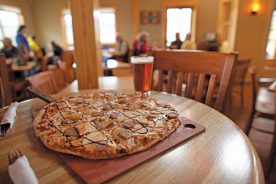 The German-style bratwurst pizza at Blue Mountain Brewery gets a kiss of Italian flavors with caramelized sweet onions, mozzarella and house-made marinara sauce.