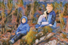 Sam and Eli pause in their spring wildflower searches for a break on their favorite sitting log.