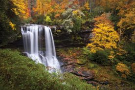 Western North Carolina photographer Dave Allen  won our recent Facebook photo contest with this shot, which he calls Autumn at Dry Falls. In case you want to visit:
Where it is:  Outside of Highlands, N.C.
How to get there: Take U.S. 64 west out of Highlands toward Franklin. 
To reach it:  There is newly remodeled parking and restrooms, and a handicap-accessible viewing platform for those who can’t make it down the stairs and trail to the falls. The steps and groomed trail lead down to the falls and even behind the waterfall.
 Why it’s worth the short walk:  It’s easily one of the most beautiful waterfalls in the Southern Appalachians in Allen’s opinion, and considering the ease of access it should be high on anyone’s list of places to visit.

For more photos from our contest, visit: 
BlueRidgeCountry.com/Waterfalls
