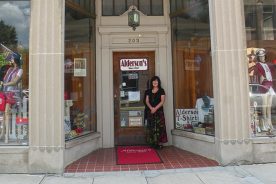 Sarah Alderson stands outside the historic store bearing her family’s name in the town also carrying that name.