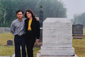 Ekachai Uekrongtham, a playwright who wrote a musical about Chang and Eng Bunker, stands with Tanya Jones at the
grave of her great-great-grandfather.