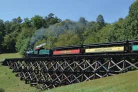 Roll on, Tweetsie: Engine No. 12 pulls passenger cars over a wooden trestle at Tweetsie Railroad in Blowing Rock, North Carolina.