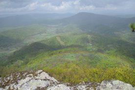 View is from McAfee Knob toward Tinker Cliffs (to right, at the end of the ridge). Rainbow in foreground courtesy of light drizzle out of a pretty nice day.
