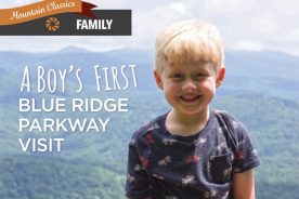 Kayden grins at Jumpinoff Rock Overlook in Glendale Springs, North Carolina, along the parkway.