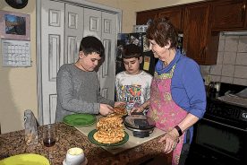 Sam, Eli and Elaine prepare wild persimmon waffles as a reward for the boys’ and Granddad’s labors in preparing for winter weather.