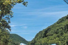 Rafters carry their float out of the New River under the New River Gorge Bridge near Fayetteville.
