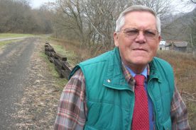 Saltville Tourism Director Charlie Totten stands next to the town's rails-to-trails project.