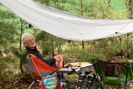 Gail stays comfy in rain under the tarp at Carvins Cove, 9/11/22.