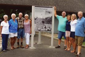 Children of Woodrow and Lavada Golding pose at the welcome sign at Rocky Knob Visitor Center, 2015. Left to right, oldest to youngest: Shirley Williams, Janet Breen, John Golding, Eula Walters, Ernie Golding, Kay Wood, Nancy Pharr and Allison Golding.