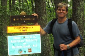 Apparently one way Americans are being put to work is through putting up a lot of signs in the woods.