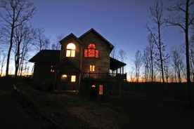 Late evening light casts David Fason and Diane Johnson’s Floyd County house in silhouette.