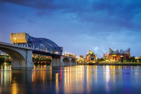 The Market Street Bridge and downtown Chattanooga reflect on a calm-surfaced Tennessee River.