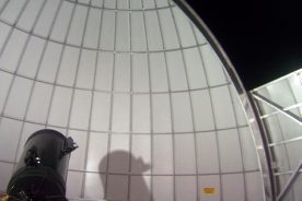 The Primland Resort observatory telescope casts a shadow against the inside of the dome.