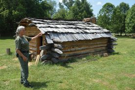 Park manager Jackie Fischer shows off a recently built replica of the David Crockett birthplace cabin near Limestone, Tennessee.
