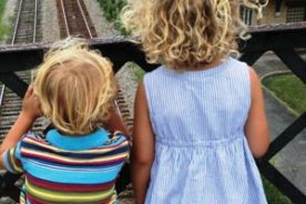The Yokim kids wait to watch a train in Abingdon.