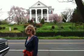 Certain hints of an urban walk: Hiker has no backpack; Ford truck in foreground along a city street; big old house from the glory days of Memorial Avenue, circa 1920, picked as photo focal point by The Day Hiker for its spring-has-sprung front yard.